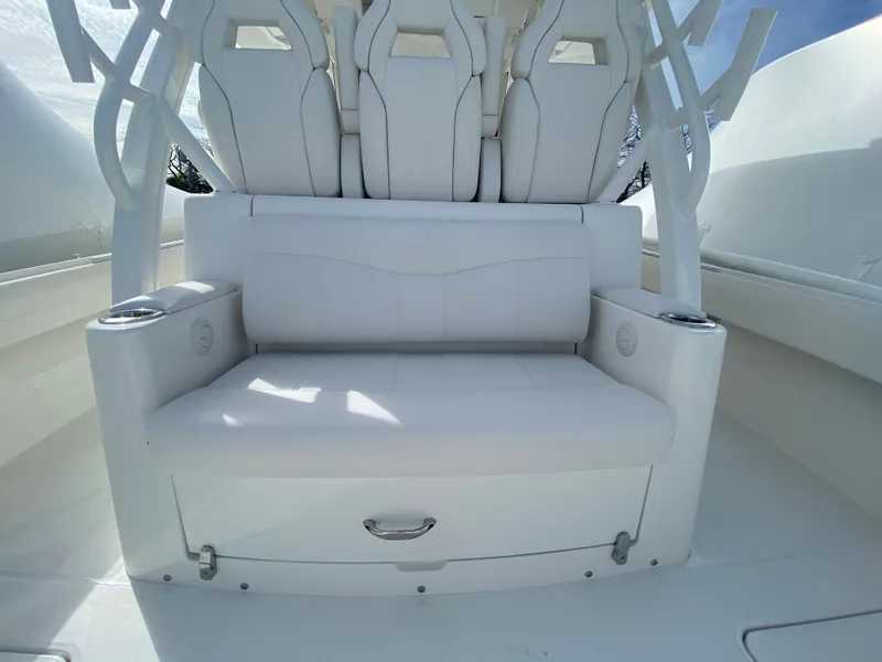 Slide: The Image of 2024 Regulator 37 boat seating area with white cushioned seats and modern design. - 45