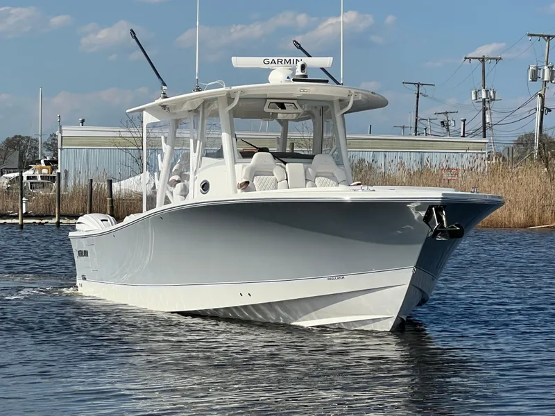 Slide: The Image of 2024 Regulator 37 boat on water, featuring sleek design and advanced Garmin navigation system. - 5
