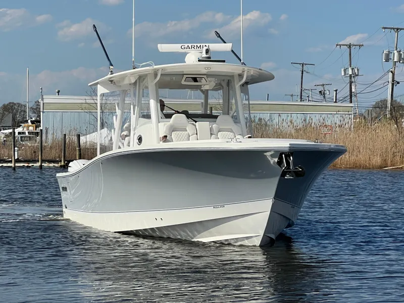 Slide: The Image of 2024 Regulator 37 boat on water, featuring Garmin equipment, clear sky background. - 6