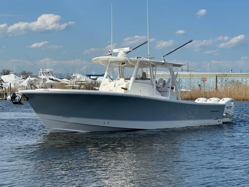 Slide: The Image of 2024 Regulator 37 boat on calm water under a clear blue sky. - 9