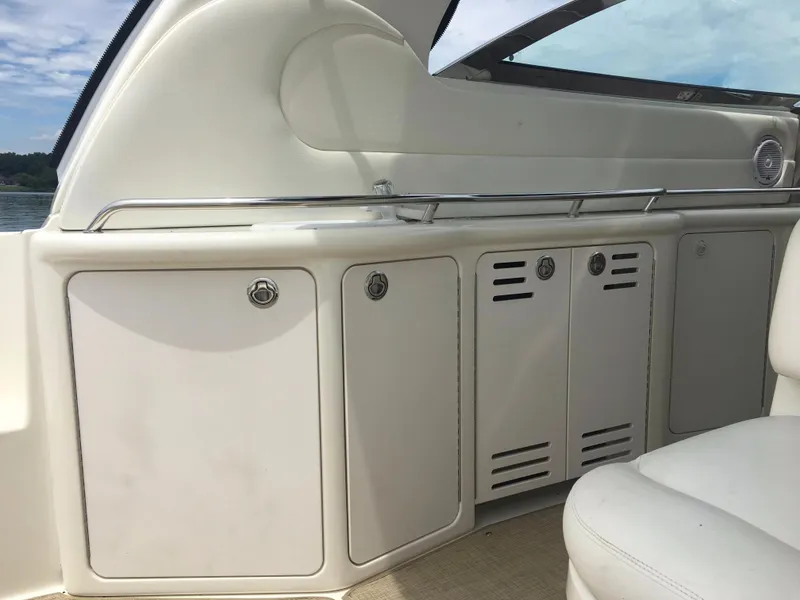 Slide: The Image of 2000 Sea Ray 410 Sundancer interior with white cabinetry and seating. - 10