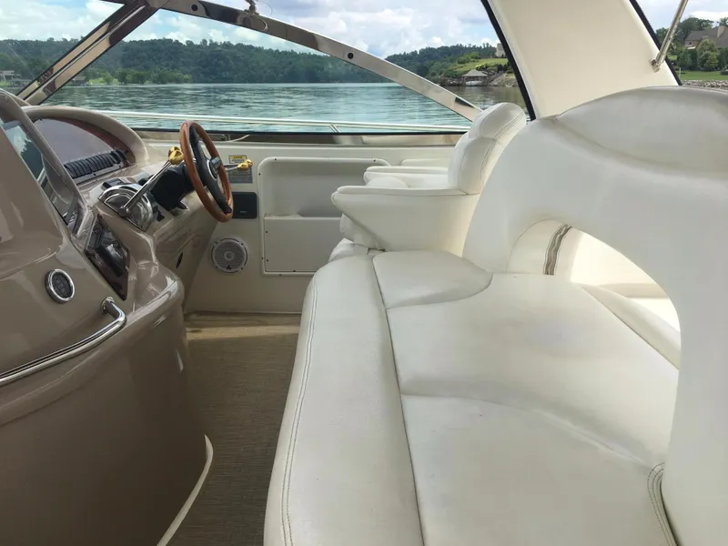 Slide: The Image of Interior of 2000 Sea Ray 410 Sundancer yacht with white seating and scenic lake view. - 14