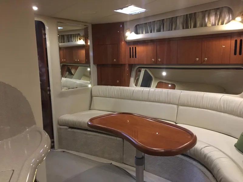 Slide: The Image of Luxurious interior of 2000 Sea Ray 410 Sundancer yacht with elegant seating and wooden accents. - 31