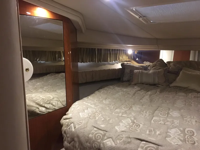 Slide: The Image of Interior cabin of 2000 Sea Ray 410 Sundancer with cozy bed and mirror. - 35