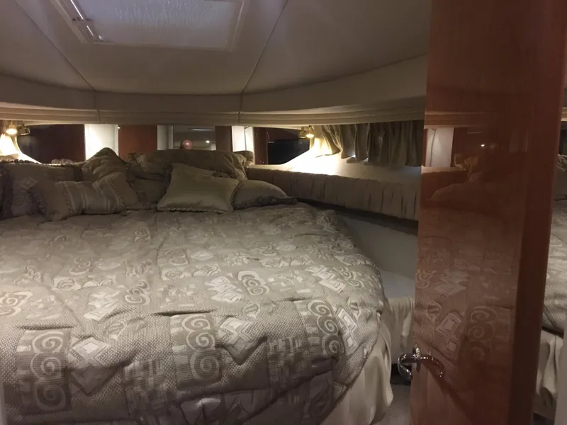 Slide: The Image of Luxurious cabin interior of 2000 Sea Ray 410 Sundancer yacht with cozy bedding. - 37