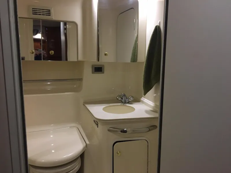 Slide: The Image of Bathroom interior of 2000 Sea Ray 410 Sundancer yacht, featuring sink and mirror. - 38
