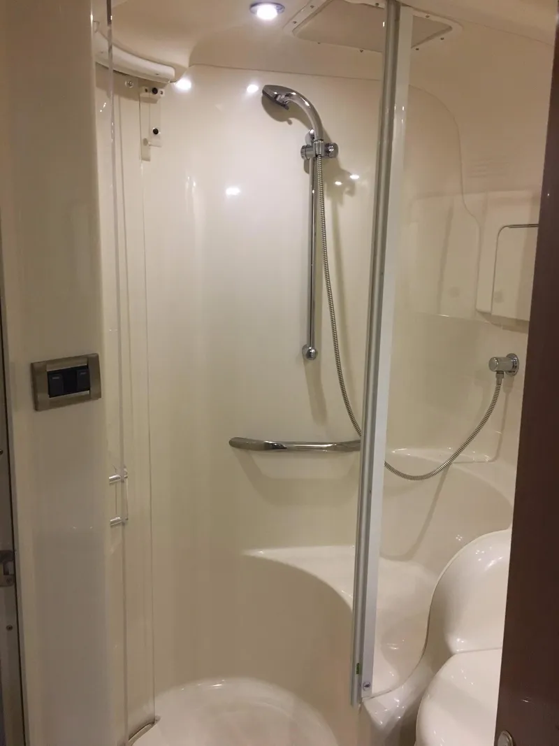 Slide: The Image of 2000 Sea Ray 410 Sundancer bathroom with shower, sleek design, modern fixtures, and bright lighting. - 39