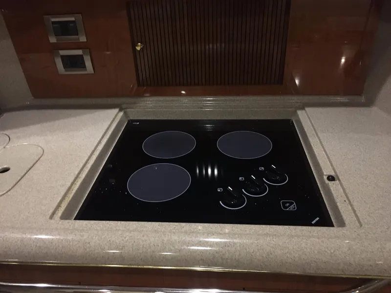 Slide: The Image of Stovetop in 2000 Sea Ray 410 Sundancer yacht kitchen, featuring sleek design and modern controls. - 42