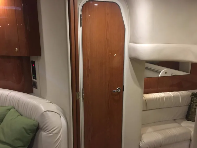 Slide: The Image of Interior of 2000 Sea Ray 410 Sundancer yacht with wooden door and white seating. - 43