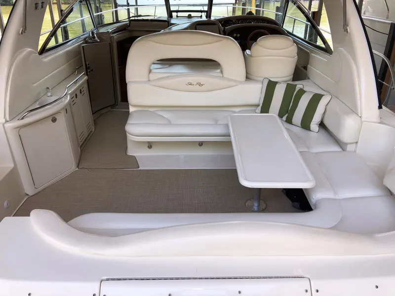 Slide: The Image of Interior of 2000 Sea Ray 410 Sundancer yacht with white seating and table. - 5