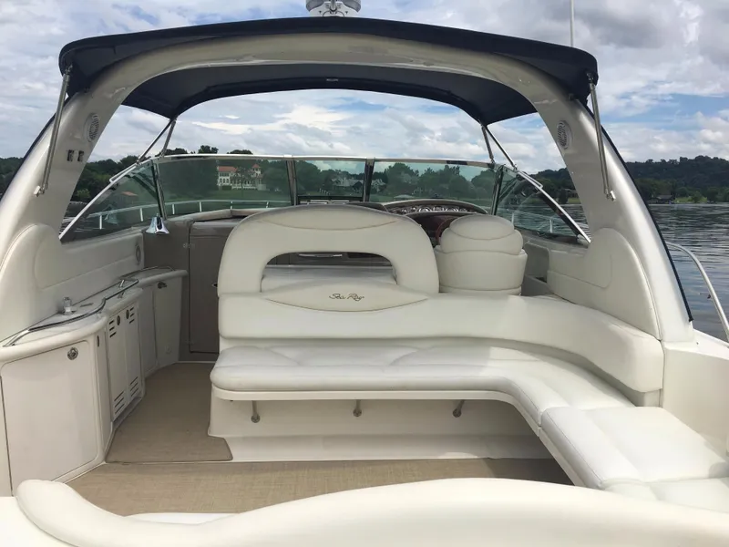 Slide: The Image of 2000 Sea Ray 410 Sundancer yacht interior with white seating and canopy. - 6