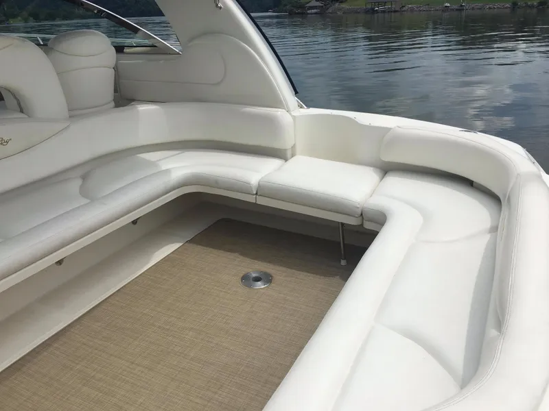 Slide: The Image of Luxurious seating area on a 2000 Sea Ray 410 Sundancer yacht, featuring white upholstery. - 7
