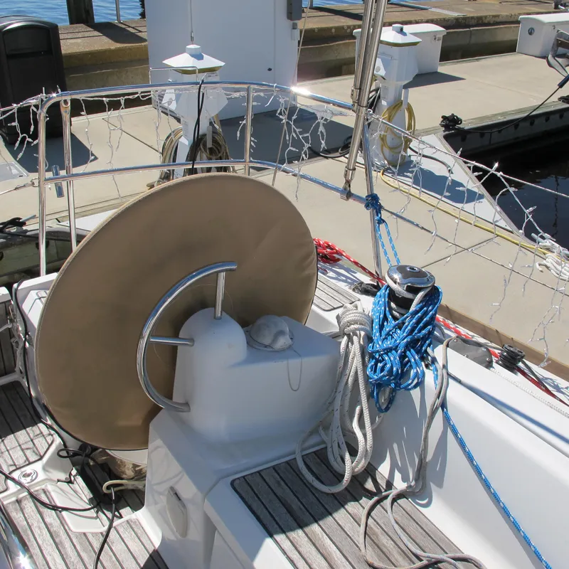 Slide: The Image of 2013 Jeanneau Sun Odyssey 379 sailboat deck with steering wheel and ropes at dock. - 18
