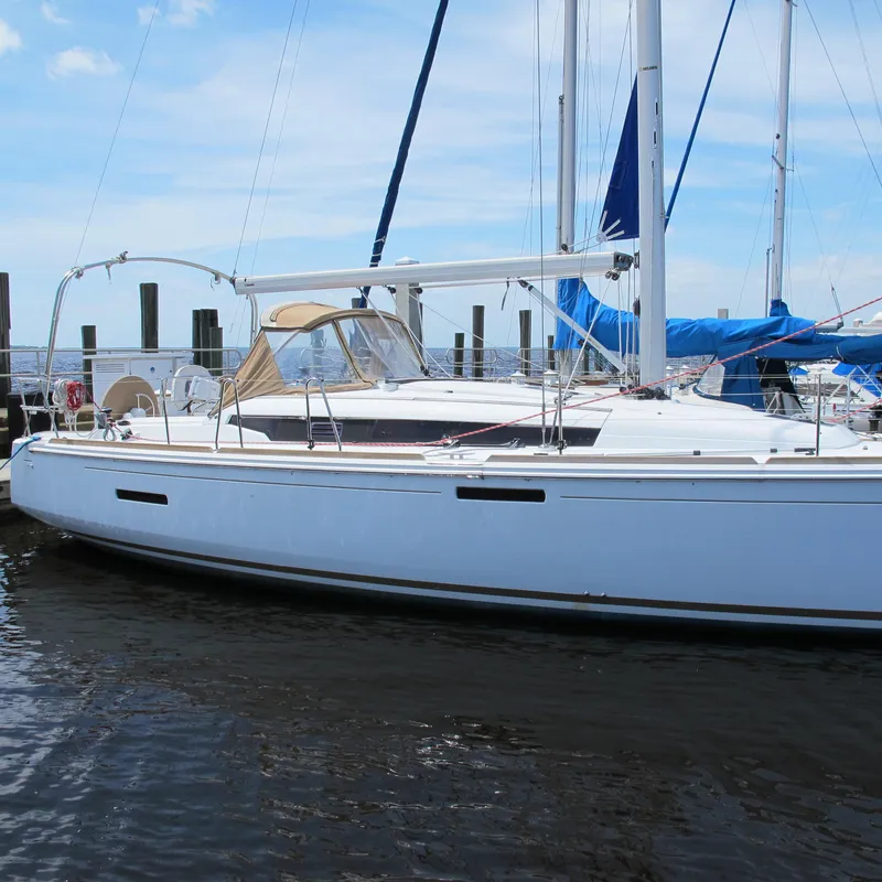 Slide: The Image of 2013 Jeanneau Sun Odyssey 379 sailboat docked at marina under blue sky. - 2