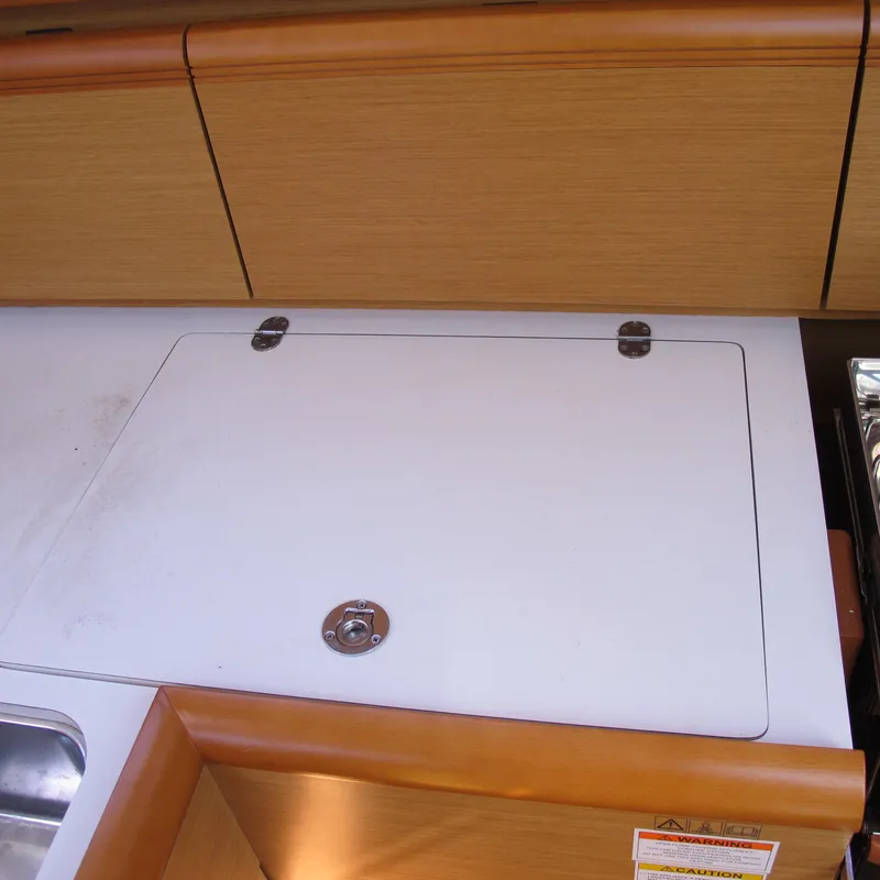 Slide: The Image of Interior of 2013 Jeanneau Sun Odyssey 379 yacht, featuring a wooden cabinet and countertop. - 27