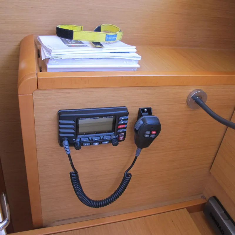 Slide: The Image of VHF radio and documents on Jeanneau Sun Odyssey 379, 2013 model, wooden interior. - 32