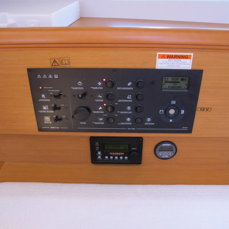 Slide: The Image of Control panel of 2013 Jeanneau Sun Odyssey 379 sailboat, featuring various switches and displays. - 33