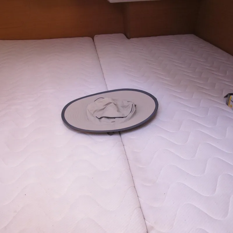 Slide: The Image of Interior cabin of 2013 Jeanneau Sun Odyssey 379 with white mattresses and a hat. - 35