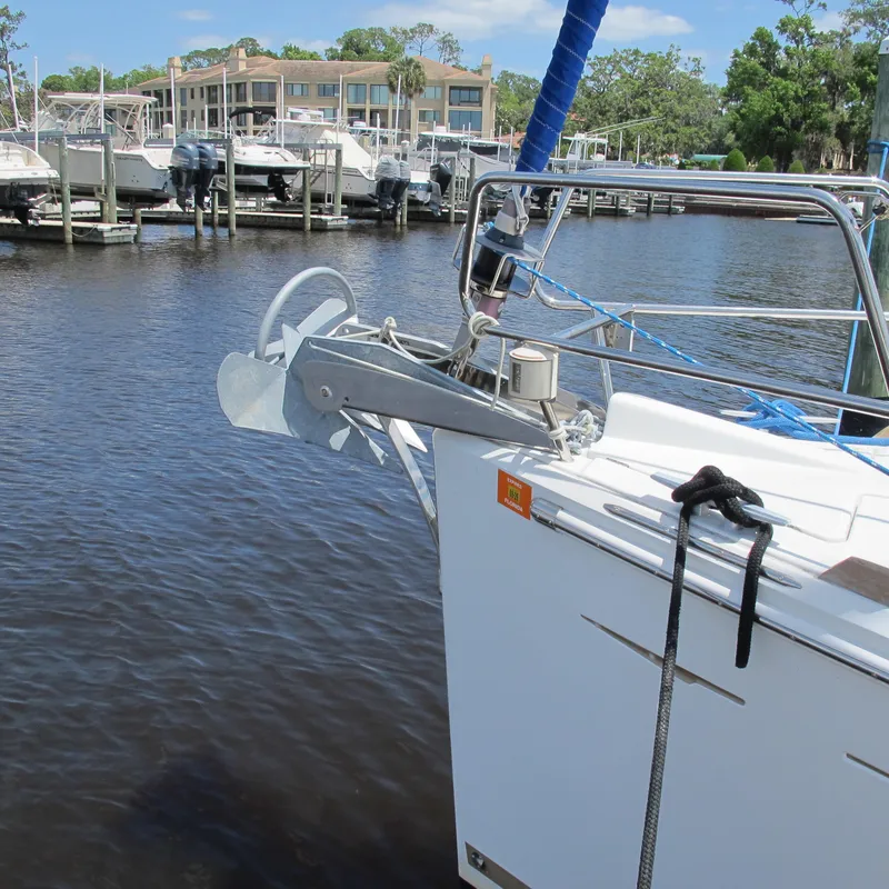 Slide: The Image of 2013 Jeanneau Sun Odyssey 379 sailboat docked at marina, featuring anchor and bow details. - 4
