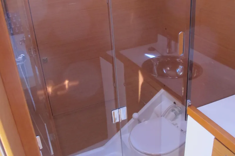Slide: The Image of Bathroom interior of 2013 Jeanneau Sun Odyssey 379 yacht, featuring modern fixtures and wooden accents. - 41