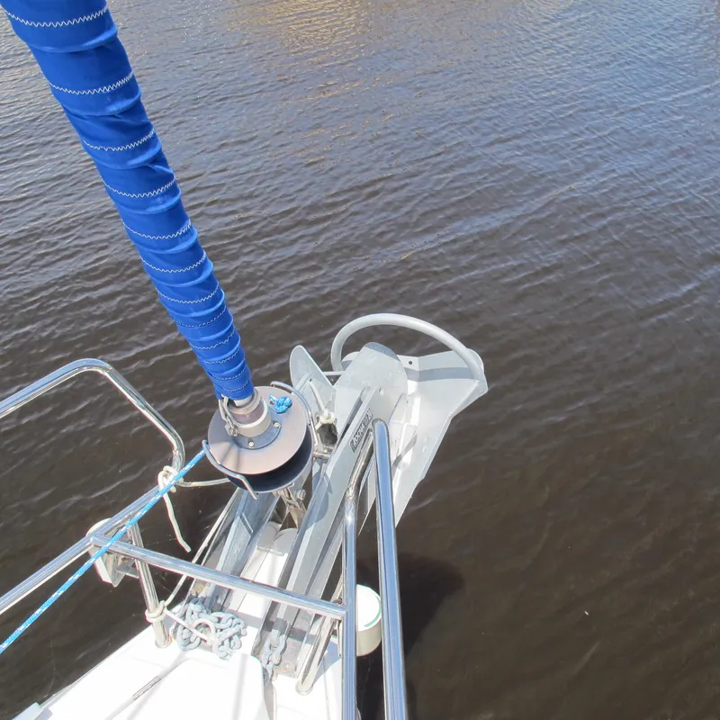 Slide: The Image of Bow of 2013 Jeanneau Sun Odyssey 379 sailboat with blue sail cover on calm water. - 5