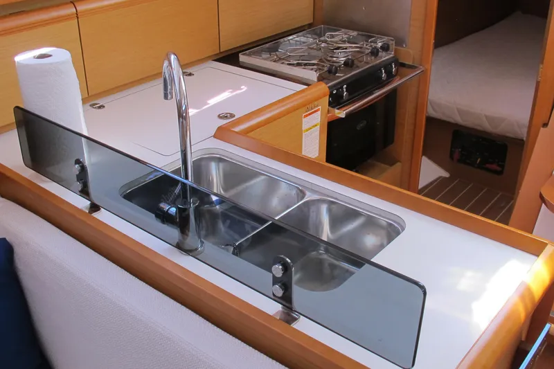 Slide: The Image of Galley kitchen in 2013 Jeanneau Sun Odyssey 379 sailboat with sink and stove. - 70
