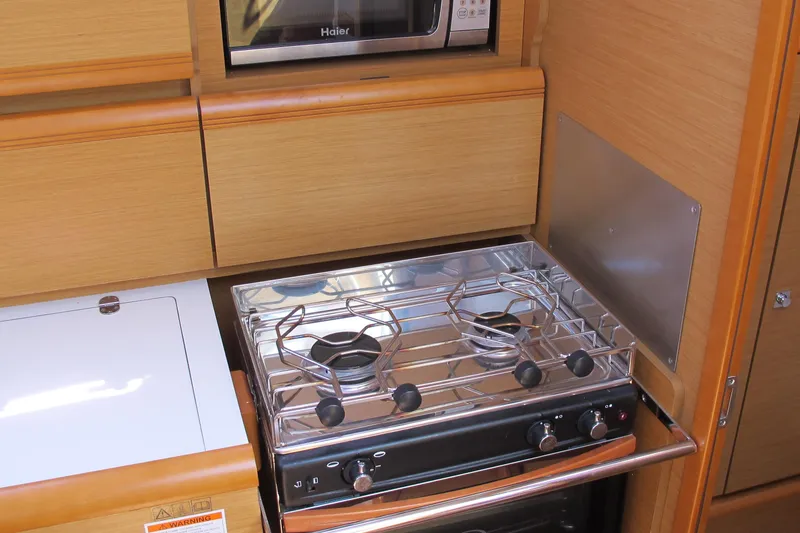 Slide: The Image of Compact kitchen in 2013 Jeanneau Sun Odyssey 379 yacht with stove and microwave. - 71