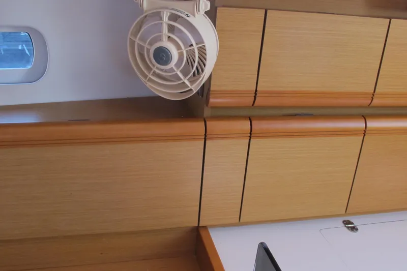 Slide: The Image of Interior of 2013 Jeanneau Sun Odyssey 379 yacht with wooden cabinets and fan. - 77