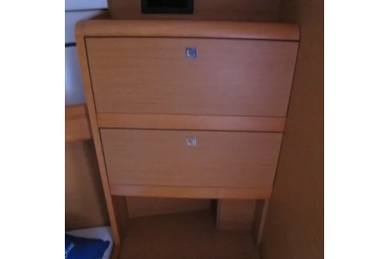 Slide: The Image of Wooden storage drawers inside a 2013 Jeanneau Sun Odyssey 379 sailboat cabin. - 78