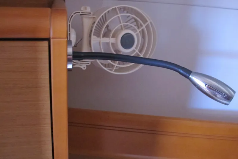 Slide: The Image of Interior detail of a 2013 Jeanneau Sun Odyssey 379, featuring a flexible reading light and fan. - 79