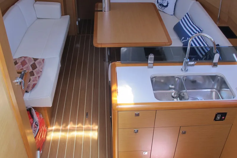 Slide: The Image of Interior of 2013 Jeanneau Sun Odyssey 379 yacht with modern kitchen and seating area. - 87