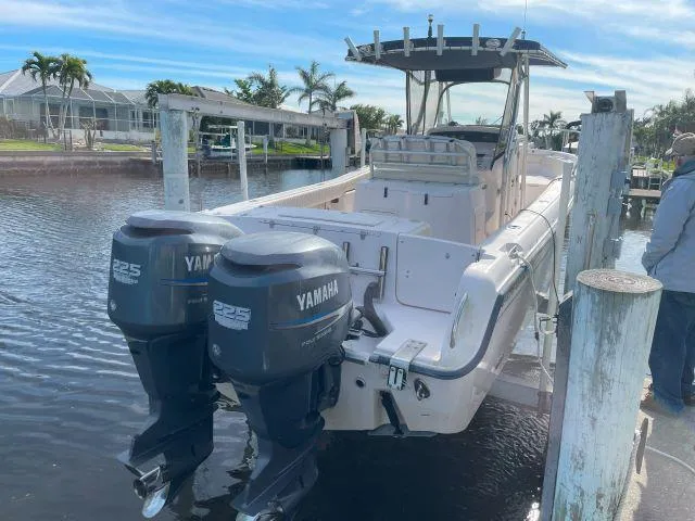 Slide: The Image of 2005 Grady-White 283 RELEASE boat with twin Yamaha 225 engines docked by the water. - 3