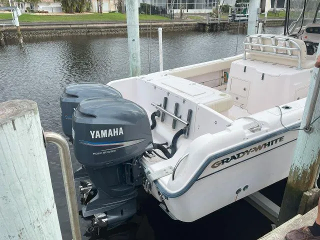 Slide: The Image of 2005 Grady-White 283 RELEASE boat with twin Yamaha outboard motors docked by the water. - 4