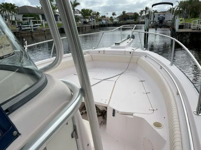Slide: The Image of 2005 Grady-White 283 RELEASE boat, spacious deck, docked in a serene marina setting. - 7