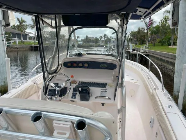 Slide: The Image of 2005 Grady-White 283 RELEASE boat interior at dock, featuring steering console and controls. - 8