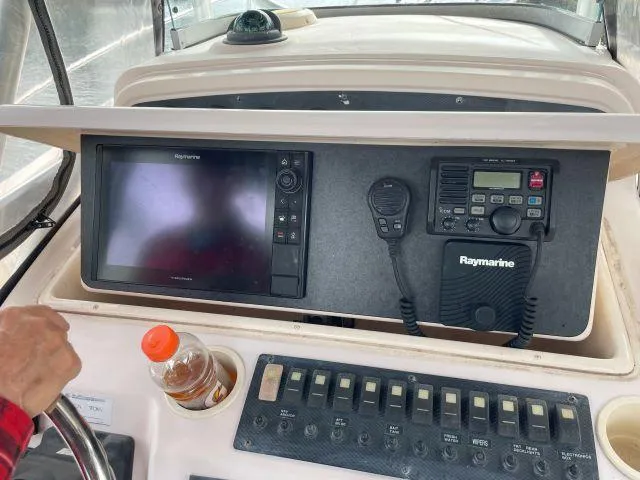 Slide: The Image of 2005 Grady-White 283 RELEASE boat dashboard with Raymarine electronics and control panel. - 9