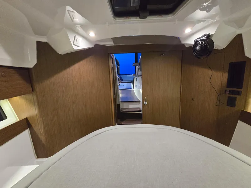 Slide: The Image of Interior cabin of 2021 Jeanneau NC895 boat with wood paneling and modern design. - 13