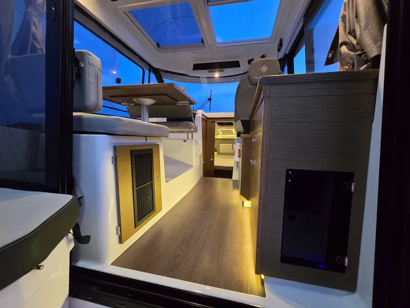 Slide: The Image of Interior of 2021 Jeanneau NC895 boat, featuring modern design and ambient lighting. - 14
