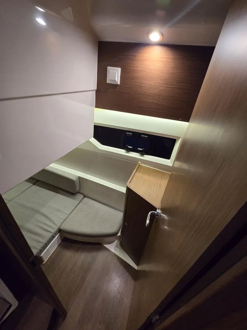 Slide: The Image of 2021 Jeanneau NC895 cabin interior with modern lighting and cozy seating. - 16