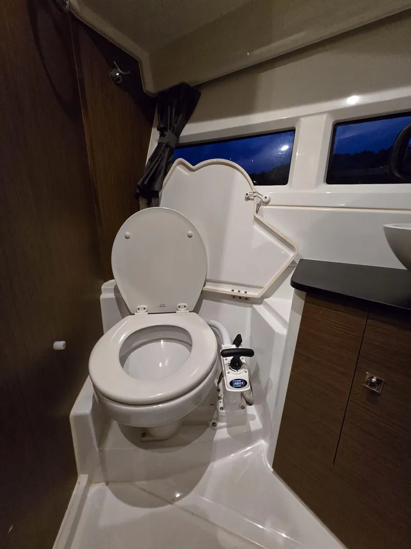 Slide: The Image of 2021 Jeanneau NC895 boat bathroom with modern toilet and sleek design. - 18