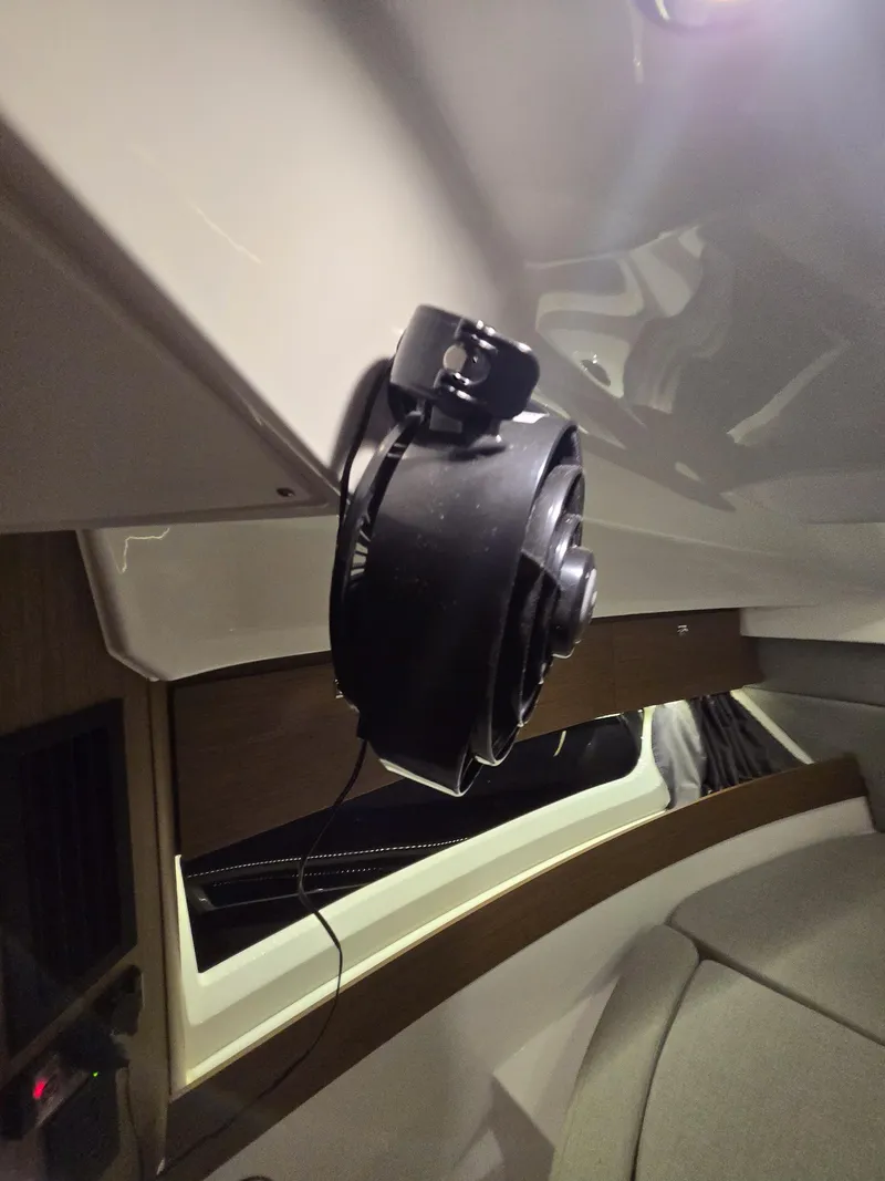 Slide: The Image of Interior view of a 2021 Jeanneau NC895 boat, featuring a mounted fan. - 19
