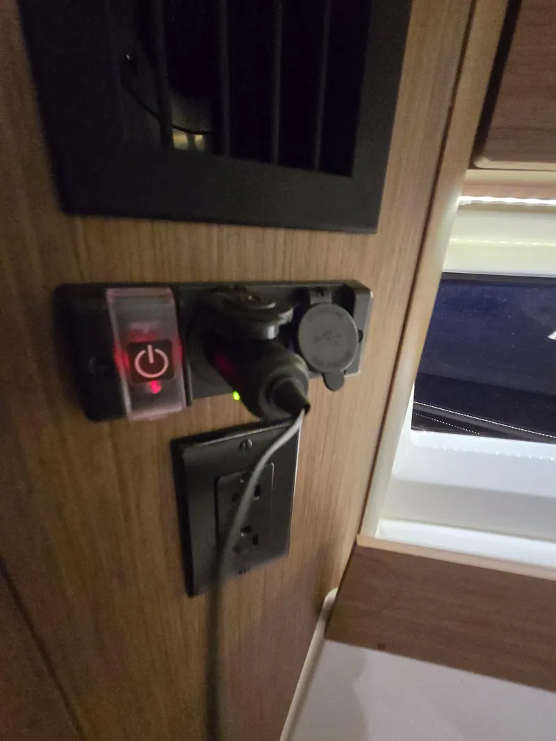 Slide: The Image of Power outlet and switch panel inside a 2021 Jeanneau NC895 boat cabin. - 20