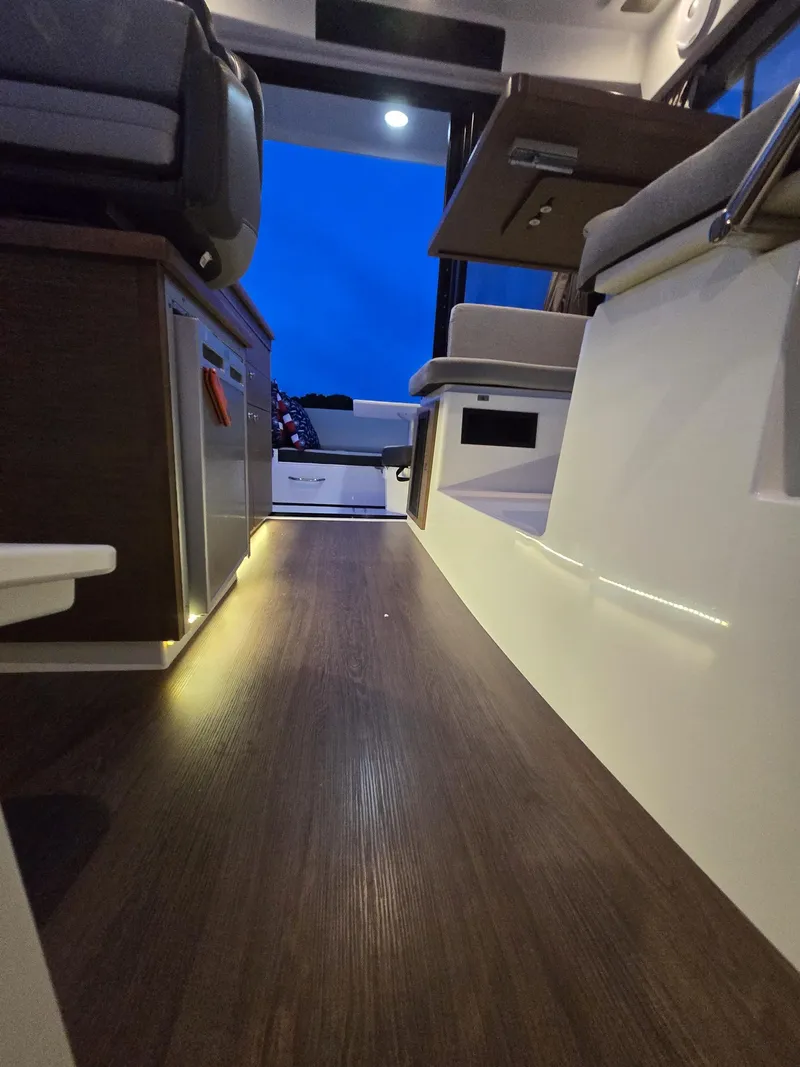Slide: The Image of 2021 Jeanneau NC895 interior with modern design and ambient lighting. - 23