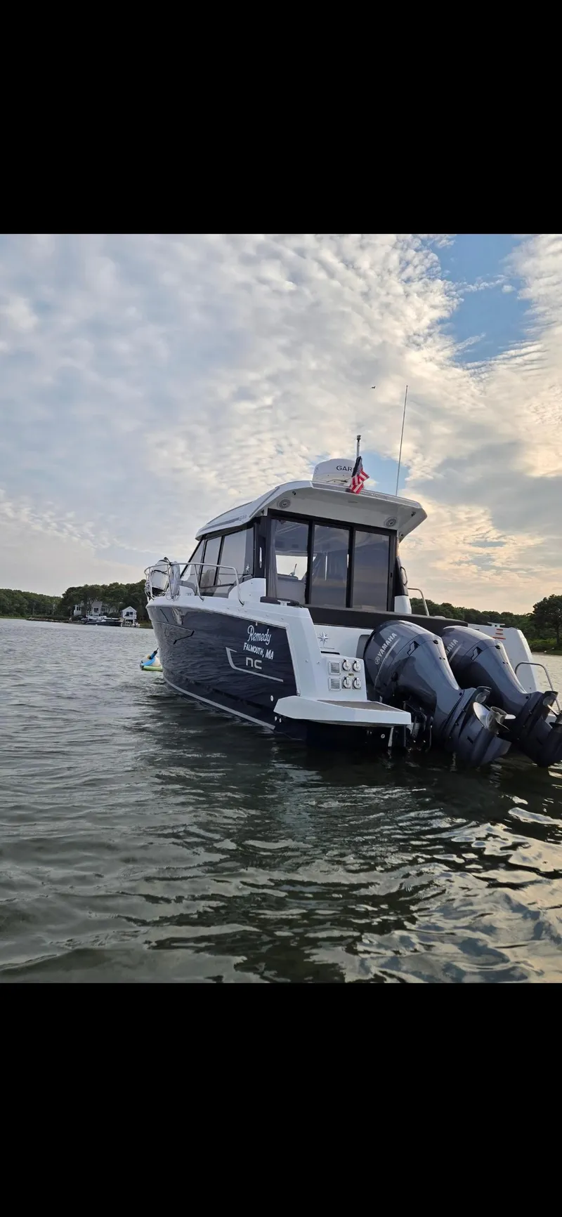Slide: The Image of 2021 Jeanneau NC895 boat on calm water with twin outboard motors. - 34