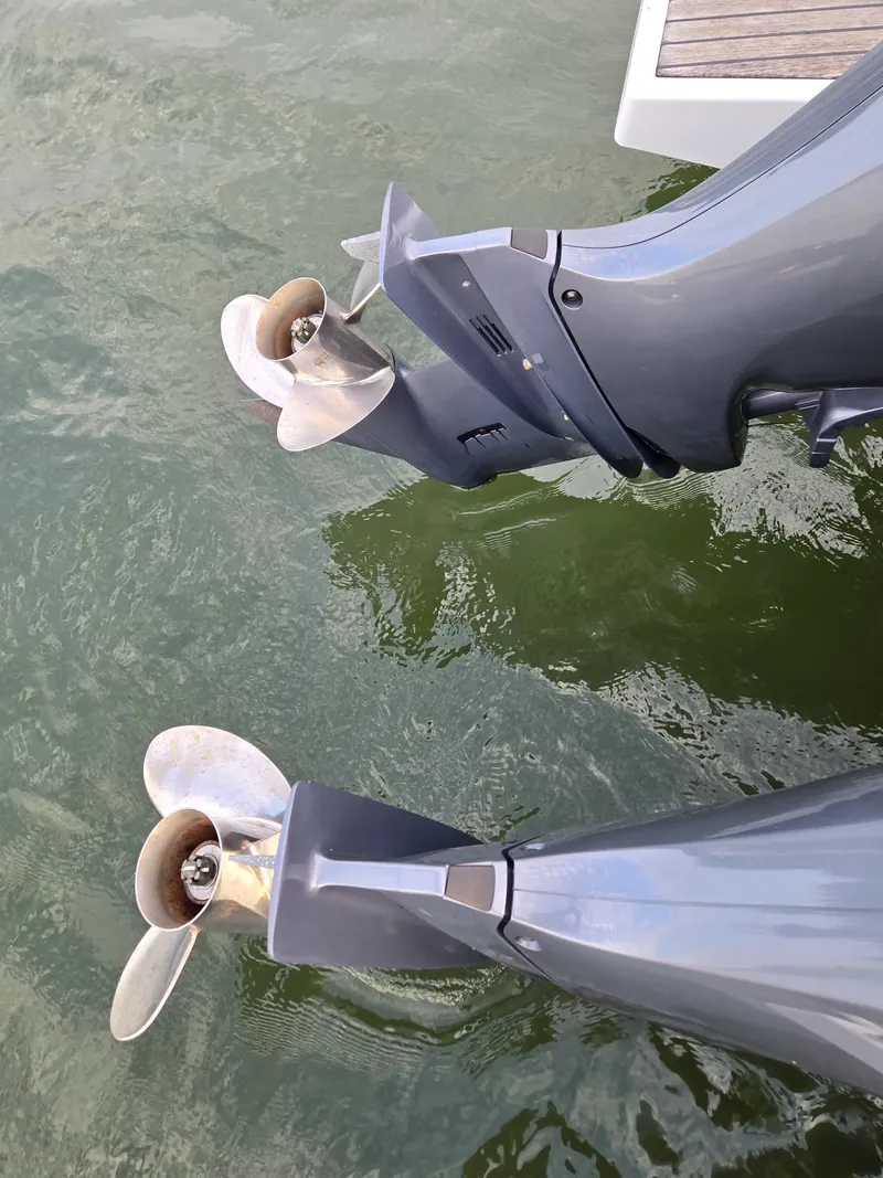 Slide: The Image of Twin outboard motors on a 2021 Jeanneau NC895 boat in water. - 36
