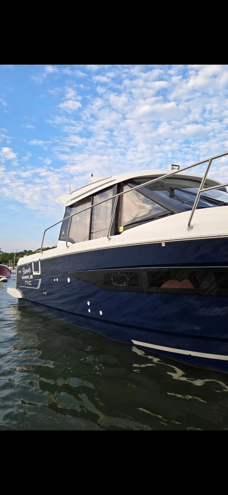 Slide: The Image of 2021 Jeanneau NC895 boat on water under a partly cloudy sky. - 38