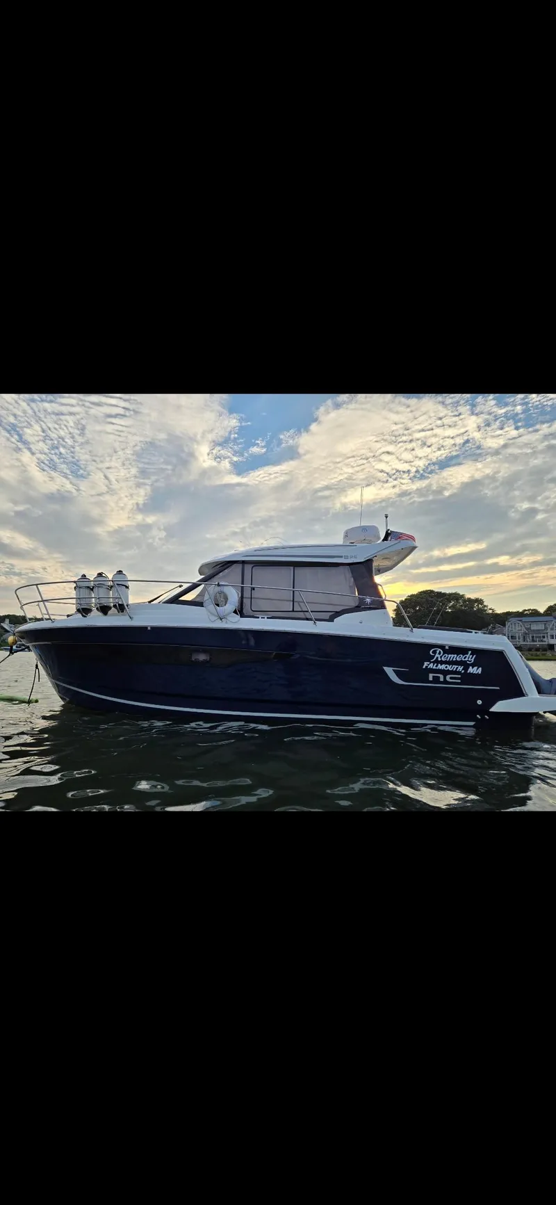 Slide: The Image of 2021 Jeanneau NC895 boat on water at sunset with cloudy sky. - 39