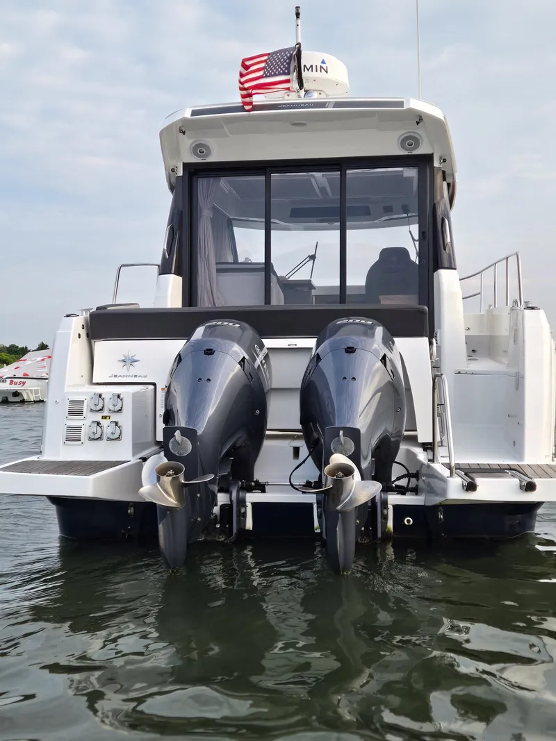 Slide: The Image of 2021 Jeanneau NC895 boat with dual outboard motors on water. - 40