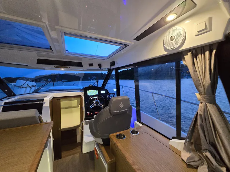 Slide: The Image of Interior of 2021 Jeanneau NC895 boat with modern helm and panoramic windows. - 8