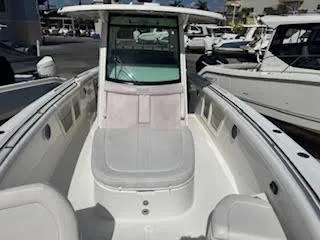 Slide: The Image of 2016 Boston Whaler 350 Outrage boat, spacious deck, white interior, docked at marina. - 12